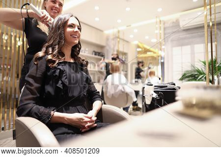 Portrait Of Haircutter Speaking With Client. Smiling Female Person Sitting In Comfortable Armchair. 