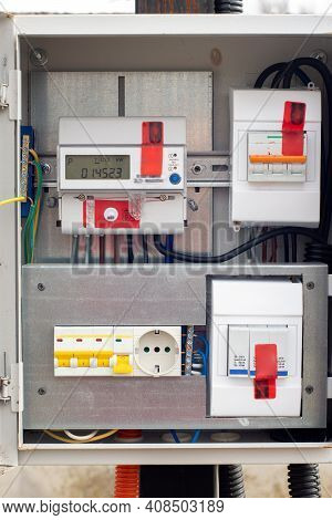 An Introductory Machine And An Electric Energy Meter In A Dashboard On A Pole Close-up