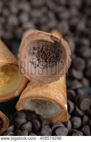 Close Up Photo Of Sweet Conus Candy On Chocolate. Brown Background