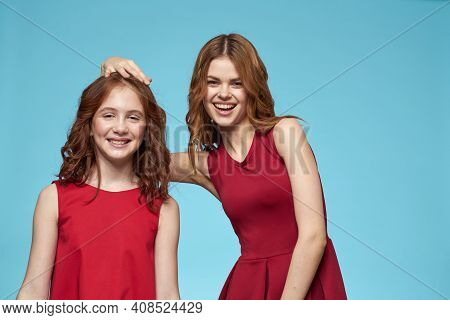 Mom And Daughter In Red Dresses Entertainment Lifestyle Fun Studio Blue Background