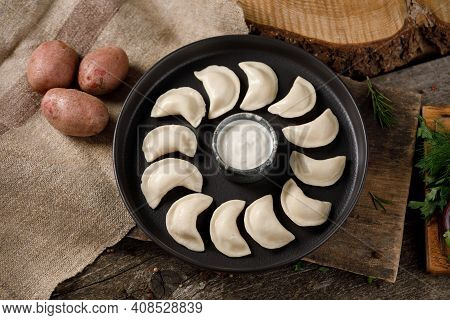Appetizing Traditional Russian Dumplings, Hand-made With Potatoes. Still Life On A Wooden Board. Clo