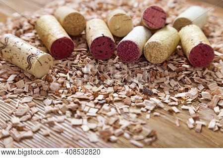 Used Corks From Wine Spread Out On Wood Sawdust. Background From Natural Wood Materials With Wine St