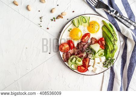 Plate With A Keto Diet Food. Paleo Keto Breakfast Fried Eggs, Bacon, Avocado, Cheese And Fresh Salad