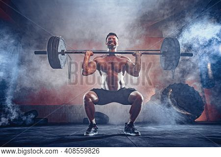 Muscular Fitness Man Doing Deadlift A Barbell Over His Head In Modern Fitness Center. Functional Tra