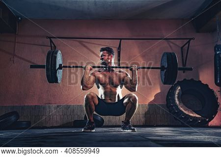 Muscular Fitness Man Doing Push A Barbell Over His Head In His Garage, Selfisolation. Functional Tra