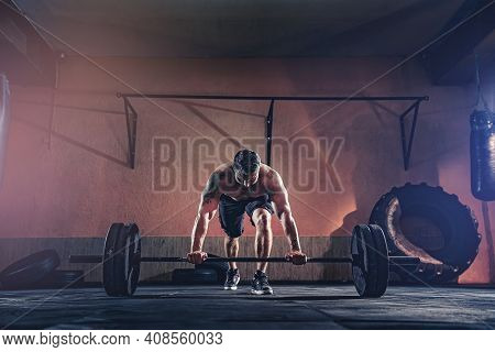 Muscular Fitness Man Doing Push A Barbell Over His Head In His Garage, Selfisolation. Functional Tra