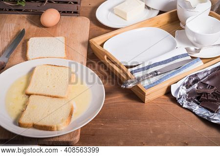 Making French Toast - Bread Soaked In Beaten Eggs.