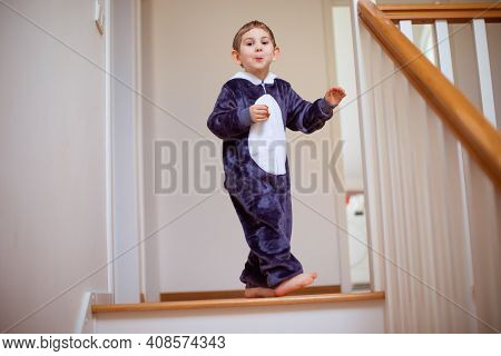 The Happy Child In Kigurumi Is Resting Alone At Home