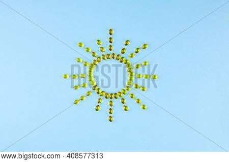 Yellow Capsules With Vitamin D3 In The Form Of The Sun With Rays. Healthy And Medical Concept, Sunsh