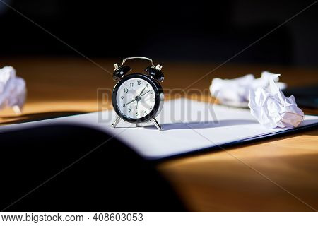 Modern Workplace, Wooden Office Desk In Hardlight, Sunligt With Clock, Sheet Of Paper
