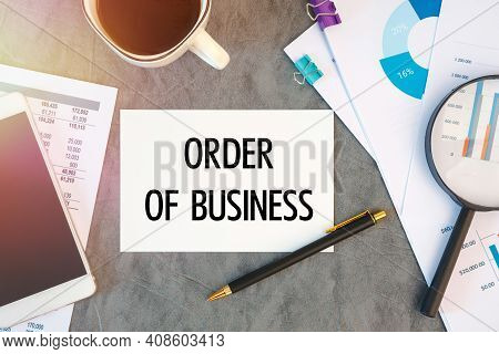 Order Of Business Is Written In A Document On The Office Desk With Office Accessories, Coffee, Diagr