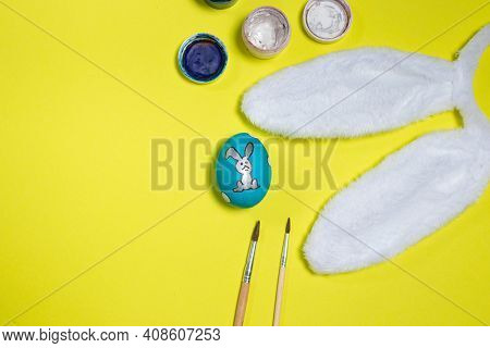 Easter Layout: Egg, Paint, Tasses And Rabbit Ears On A Yellow Background With Room For Text. View Fr