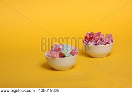 Two Bowls Of Rahat Lakoum Isolated On Yellow Background Horizontal Image. Turkish Sweet Concept