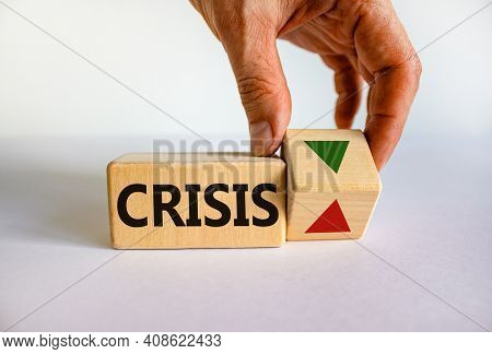 Crisis Symbol. Wooden Cube With Word 'crisis'. Businessman Turns The Wooden Cube, Changes The Direct