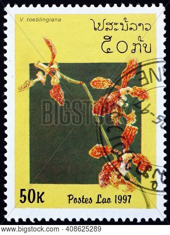Laos - Circa 1997: A Stamp Printed In Laos Shows Roebelens Vanda, Vanda Roeblingiana, Is A Species O
