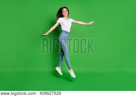 Full Length Photo Of Positive Girl Jump Isolated Over Breen Vibrant Color Background