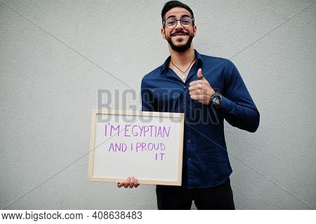 Proud To Be Egyptian. Middle Eastern Man Wear Blue Shirt, Eyeglasses, Hold Board.