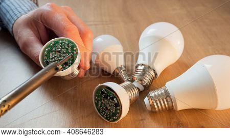 Man Repairing A Led Lamp With A Soldering Iron