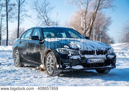 Riga, Latvia. January 10, 2021. Bmw G20 320 Model Covered In Snow Parked Alone In The Parking Lot.