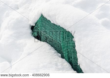 Plants And Trees In A Park Or Garden Covered By The Snow And Blanket, Swath Of Burlap, Frost Protect