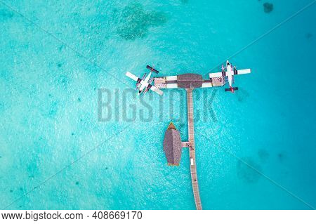 Beautiful Aerial View Of Maldives Jetty Seaplane Top View With Wooden Boat Dhoni And Tropical Beach,