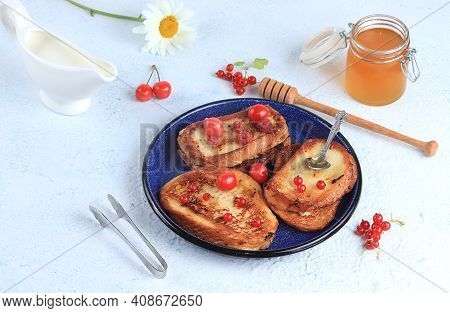 French Toast And Honey On A Gray Table With Berries And Jam. Delicious Healthy French Breakfast. Fri
