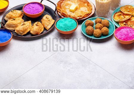 Traditional Indian Festival Food And Gulal Colors. Happy Holi Concept.