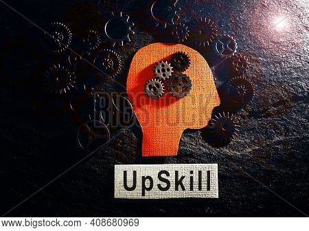 Head And Gears With Upskill Text On Textured Background