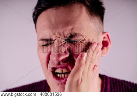 Crop Person Slapping Scared Man In Face. Emotional Male Getting Slapped In Face While Shouting With