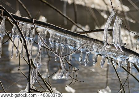 Light Reflected Through Icicles At A River In Winter Time