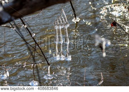 Light Reflected Through Icicles At A River In Winter Time