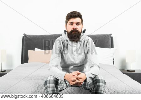 Tips For Waking Up Early. Man Bearded Hipster Sleepy Face Pajamas Waking Up Bedroom Interior. Daily 