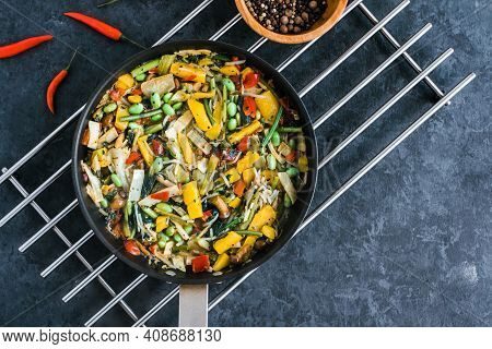Fresh Asian Vegetables Mix, Thai Wok In A Black Pan On The Black Background With Copy Space. Healthy
