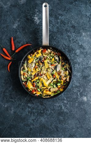 Fresh Asian Vegetables Mix, Thai Wok In A Black Pan On The Black Background With Copy Space. Healthy