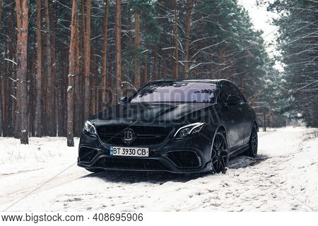 Kherson, Ukraine - February 2021. Powerful Mercedes-amg E63s Brabus 800 In A Black Color In The Wint