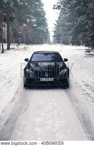 Kherson, Ukraine - February 2021. Powerful Mercedes-amg E63s Brabus 800 In A Black Color In The Wint