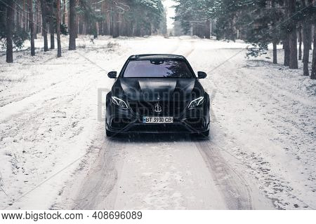 Kherson, Ukraine - February 2021. Powerful Mercedes-amg E63s Brabus 800 In A Black Color In The Wint
