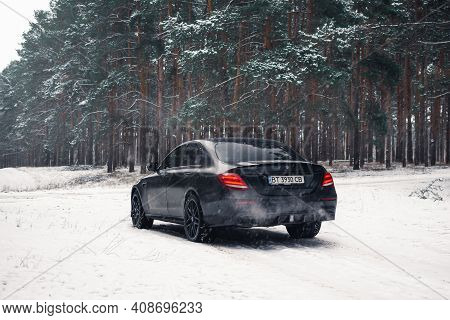 Kherson, Ukraine - February 2021. Powerful Mercedes-amg E63s Brabus 800 In A Black Color In The Wint