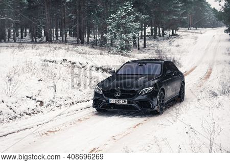 Kherson, Ukraine - February 2021. Powerful Mercedes-amg E63s Brabus 800 In A Black Color In The Wint