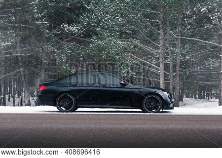 Kherson, Ukraine - February 2021. Powerful Mercedes-amg E63s Brabus 800 In A Black Color On The Empt