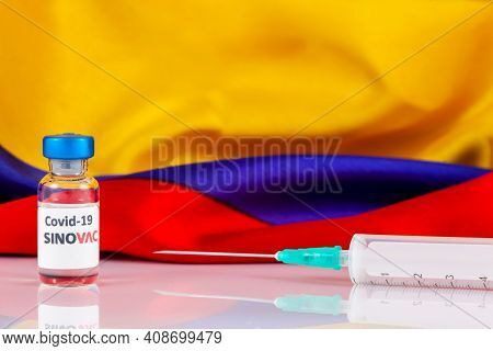 Bogota, Colombia - February 2021. Sinovac Covid Vaccine Vial And Colombian Flag. Vaccination Concept