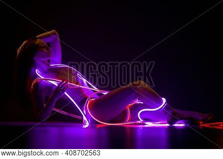 Sexy Toples Woman Lay With Ultraviolet Neon Tapes Around Body