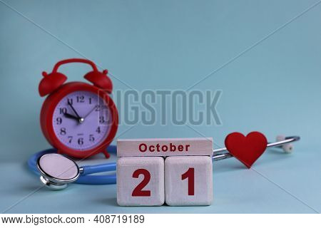 October 21. Day Of The 21th Month, Calendar Date. White Wooden Calendar Blocks With Date, Clock And 