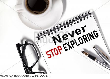 Never Stop Exploring. Text On White Notepad Paper On White Background.