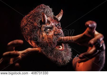 Stretch Zombie Hands. Halloween, Blood On Face. Devil Horror Concept. Demon With Bloody Horns On Hea