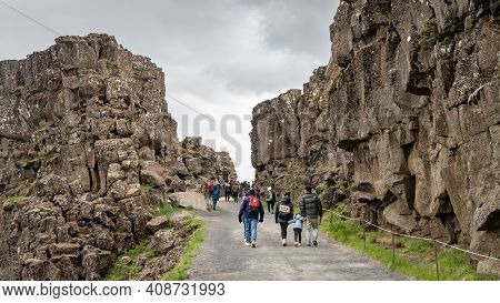 Thingvellir, Iceland - August 2019: Tourists Walking Along Thingvellir National Park With Creek Of T