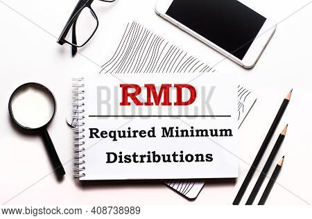 On A White Background Glasses, A Magnifier, Pencils, A Smartphone And A Notebook With The Text Rmd R