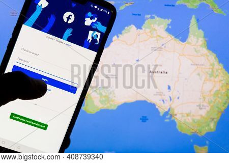 Kathmandu, Nepal - February 18 2021: Smartphone With Facebook's Login Screen Against The Maps Of Aus
