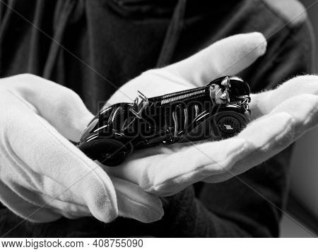 Gomel, Belarus - February 16, 2021: Portrait Of A Collector Of Retro Car Models On A Black Backgroun