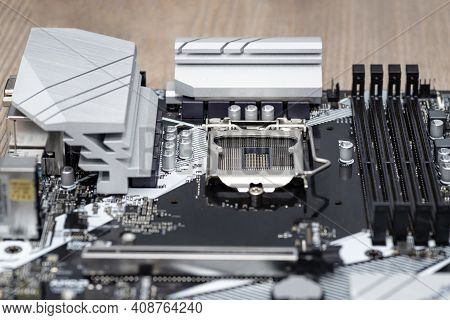 A Modern Desktop Motherboard In Black Color With A Visible Socket 1200 For The Cpu, Memory Slots Ddr